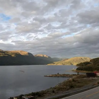 a large body of water with mountains in the background at Overnatting Rodal in Valsøybotn
