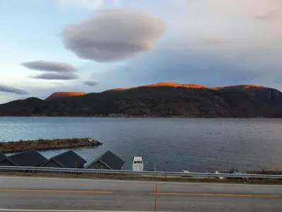 a view of a large body of water with mountains at Overnatting Rodal in Valsøybotn