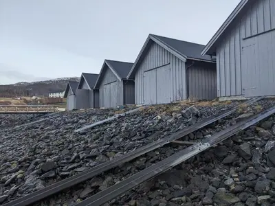 a row of buildings with train tracks in front at Overnatting Rodal in Valsøybotn