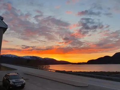 a car driving on a highway at sunset at Overnatting Rodal in Valsøybotn