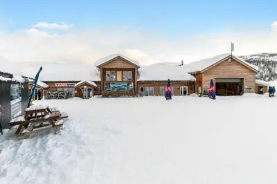 a lodge in the snow in front of a building at Leilighet - Panorama view - Sogndal Skisenter Hodlekve in Sogndal