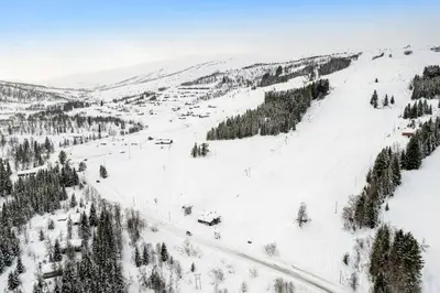 a snow covered ski slope with a ski lift at Leilighet - Panorama view - Sogndal Skisenter Hodlekve in Sogndal