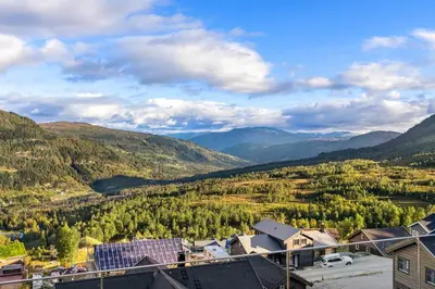 a view of a valley with mountains and houses at Leilighet - Panorama view - Sogndal Skisenter Hodlekve in Sogndal