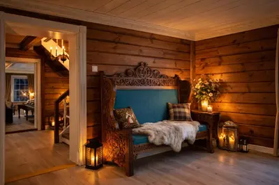 a bedroom with a bed in a room with wooden walls at Eventyrlig Tømmerhytte på Gårdstun in Vinstra