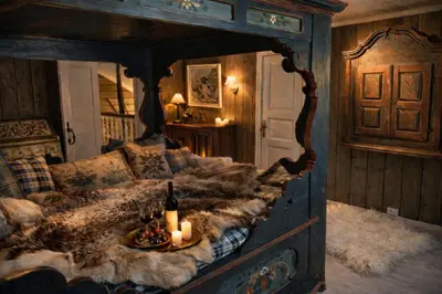 a bedroom with a large bed with candles on it at Eventyrlig Tømmerhytte på Gårdstun in Vinstra