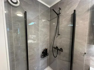 a bathroom with a shower with a glass at Lovely fully furnished apartment in Ottestad