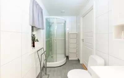 a white bathroom with a glass shower in it at Awesome Home In Ånneland With Wifi in Ånneland