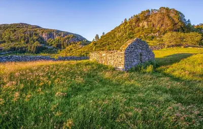 an old stone wall in a grassy field at Awesome Home In Ånneland With Wifi in Ånneland