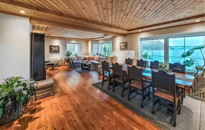 a living room with a table and chairs and a couch at 4 Bedroom Awesome Home In Tørvikbygd in Tyrvikbygd