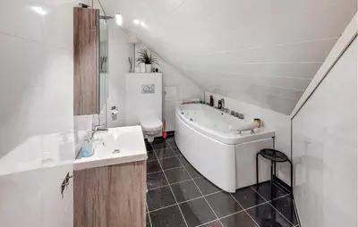 a bathroom with a tub and a sink and a toilet at 4 Bedroom Awesome Home In Tørvikbygd in Tyrvikbygd