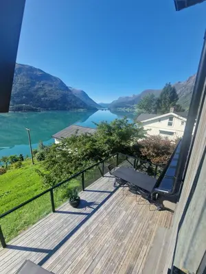 a balcony with a view of a lake at Flo Bellevue in Stryn