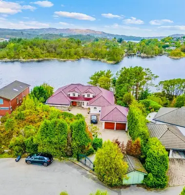 an aerial view of a house on an island in a river at Waterfront Villa w/Boat&kayaks. 15min from Bergen in Foldnes