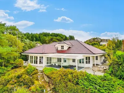 a large white house with a red roof at Waterfront Villa w/Boat&kayaks. 15min from Bergen in Foldnes