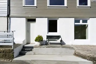 a bench sitting in front of a house at Spacious and Beautiful Apartment in Bergen with free parking in Bergen