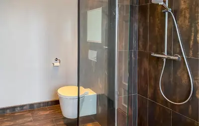a bathroom with a shower with a toilet and a glass door at 1 Bedroom Stunning Apartment In Ålesund in Ålesund