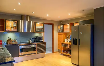 a kitchen with a stainless steel refrigerator and cabinets at Pet Friendly Home In Ålesund in Ålesund