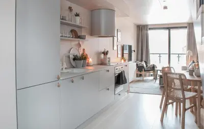 a kitchen with white cabinets and a dining room at Gorgeous Home In Bjorli With Wifi in Bjorli