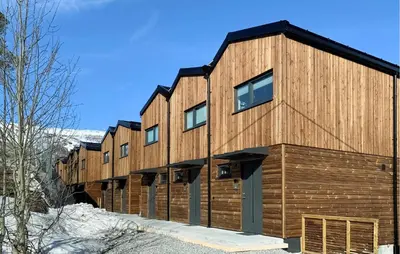 a row of wooden buildings in the snow at Gorgeous Home In Bjorli With Wifi in Bjorli
