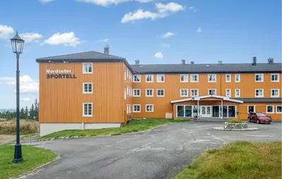 an orange building with a street light in front of it at Gorgeous Apartment In Lillehammer in Lillehammer