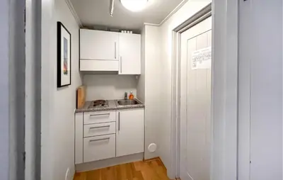 a small kitchen with white cabinets and a sink at Gorgeous Apartment In Lillehammer in Lillehammer