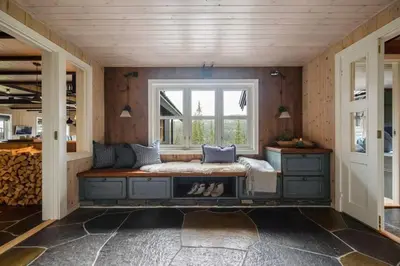 a room with a bench in front of a window at Your Ideal Getaway Awaits in This Charming Cabin Retreat in Nord Torpa