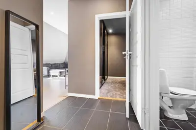 a hallway with a door open to a bathroom at Penthouse apartment in Bergen in Bergen