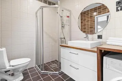 a bathroom with a toilet and a sink and a mirror at Penthouse apartment in Bergen in Bergen
