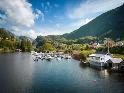 a bunch of boats are docked in a harbor at Sjötun Fjord Cabin, with boat in Stanghelle