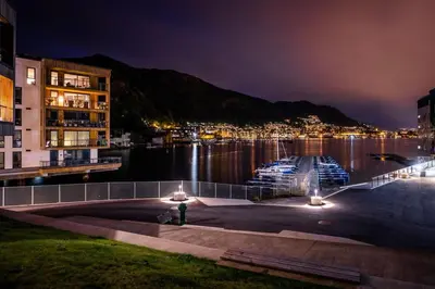 a view of a body of water at night at New penthouse apartment with sea view in Bergen centrum in Bergen