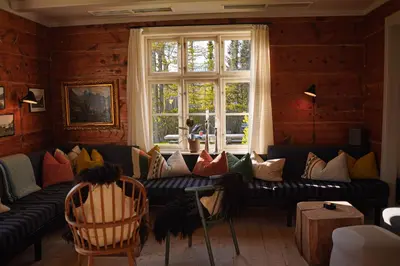 a living room with a couch and a window at Hotel Aak in Åndalsnes