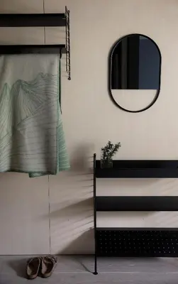 a mirror and a pair of shoes in a room at Hotel Aak in Åndalsnes