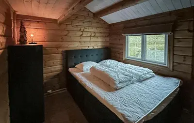 a bedroom with a bed in a wooden cabin at 3 Bedroom Gorgeous Home In Bjorli in Bjorli
