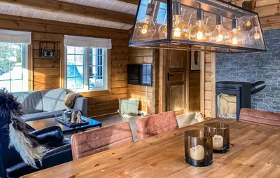 a living room with a large wooden table with chairs at 3 Bedroom Gorgeous Home In Bjorli in Bjorli