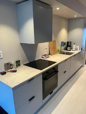 a kitchen with white cabinets and a counter top at Hyt leilighet med 2 soverom in Bjorli