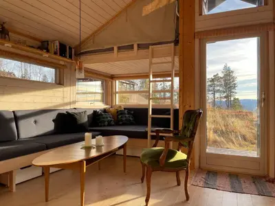 a living room with a couch and a table at Sveheim - cabin with an amazing view in Flå