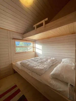 a bed in a room in a log cabin at Sveheim - cabin with an amazing view in Flå