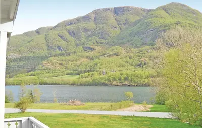 a view of a lake with mountains in the background at Holiday Home Sandeid Ilsvåg in Sandeid