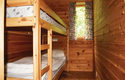 a bunk bed room with two bunk beds in a cabin at Holiday Home Sandeid Ilsvåg in Sandeid