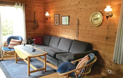 a living room with a couch and a table at Holiday Home Sandeid Ilsvåg in Sandeid