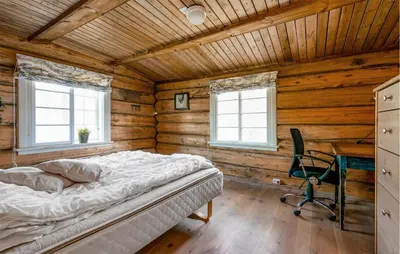 a bedroom with a bed in a wooden cabin at Nice Home In Bjorli With Wifi in Bjorli