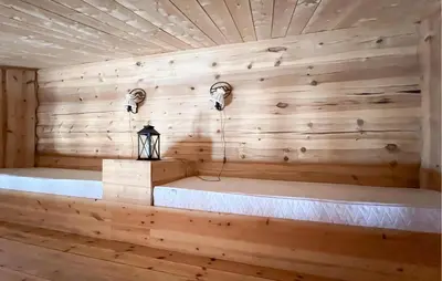 a room with a wooden wall with a bench and lights at 6 Bedroom Cozy Home In Kvam in Kvam