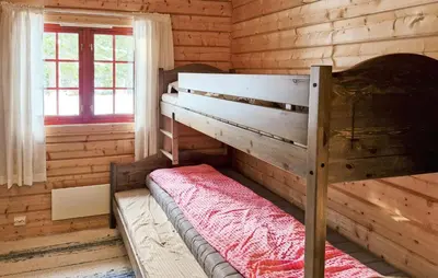a bedroom with a bunk bed in a log cabin at 4 Bedroom Pet Friendly Home In Tydal in Tydal