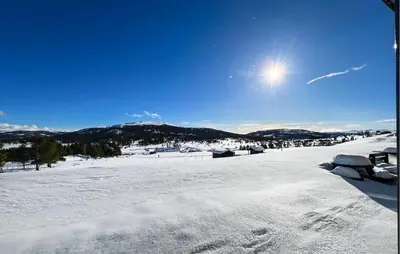 a snow covered field with the sun in the sky at Gorgeous Apartment In Kvam With Sauna in Kvam