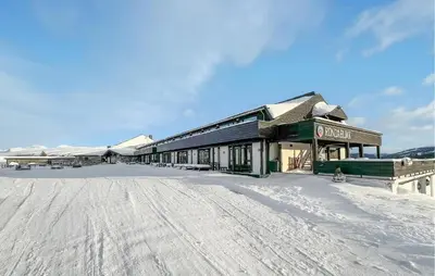a building in the snow with a snow covered ground at Gorgeous Apartment In Kvam With Sauna in Kvam