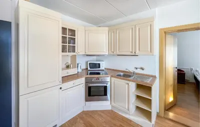a kitchen with white cabinets and a sink at Gorgeous Apartment In Kvam With Sauna in Kvam
