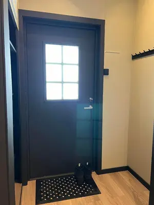 a blue door with a window and a door mat in front at Rjukan Sentrum Apartments NO 1 in Rjukan