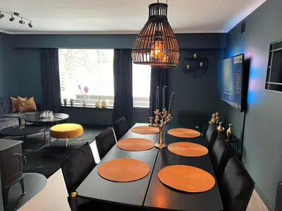 a dining room with a black table and black chairs at Rjukan Sentrum Apartments NO 1 in Rjukan