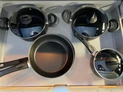 a group of pots and pans hanging on a wall at Rjukan Sentrum Apartments NO 1 in Rjukan