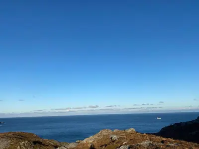 a view of the ocean from the top of a mountain at Honey bay cottage in Stadlandet