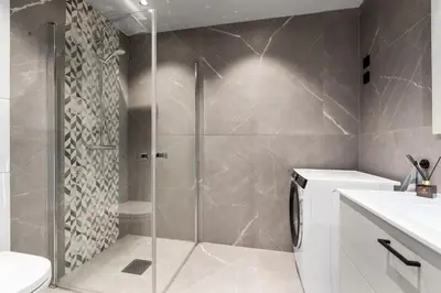 a shower with a glass door in a bathroom at Riddergaardens utsikt in Beitostøl